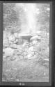 [Rocky landscape with campfire]