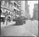 [Flatbed sightseeing tour bus on street]