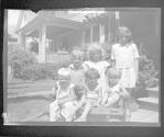 [Group of children by porch]