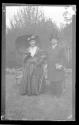 [Man & woman in costume in yard]