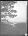 [Wooded landscape, bay in distance]