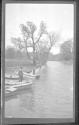 [Man fishing along river]