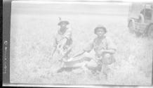 Natives posing with dead animal, African Safari