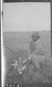 Native posing with dead animal, African Safari