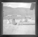 Woman and children sitting on ground