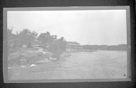 [Large building on shore of river]