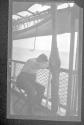 [Man with head on rail of ship]