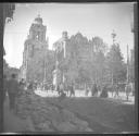 People on city street in front of cathedral