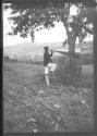 Boy yelling through megphone hung from tree