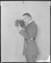 Capt. Sterling looking through motion picture camera
