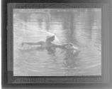 [Swimming figure with headdress]