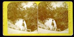 [Woman by waterfall, likely Minne-ha-ha (Laughing Water), Minnesota]