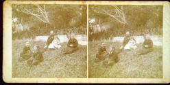[Group seated in grass]