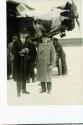 George Eastman and unidentified man standing beside airplane