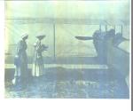 Women photographing men in biplane