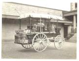 Wagon containing Eastman's camping gear in carriage house yard between carriage house and back porch