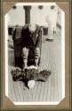 George Eastman inspecting dead eagle on ship's deck , Pacific Coast Trip