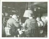 George Eastman dining with guests, Oak Lodge Trip