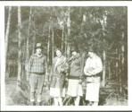Guests posing next to forest, Oak Lodge Trip
