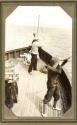 Hunting companions on ship deck, Pacific Coast Trip