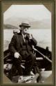George Eastman smoking cigarette in boat, Pacific Coast Trip