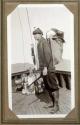 Hunting companion on ship's deck with dead eagle, Pacific Coast Trip