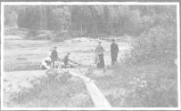 Companions with canoes by river, Grand Cascapedia Trip