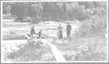 Companions with canoes by river, Grand Cascapedia Trip