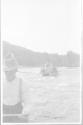 George Eastman operating motion picture camera on platform on canoes, Grand Cascapedia Trip