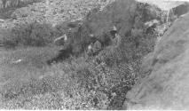 George Eastman and companions resting against rock, Wyoming Trip