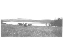 Riders in meadow near lake, Wyoming Trip