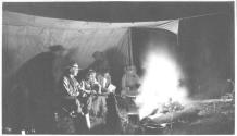 George Eastman and companions at campfire at night, Wyoming Trip