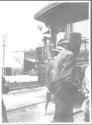 Men walking by rear of rail car, Oak Lodge trip