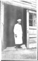 Cook in doorway, Oak Lodge Trip