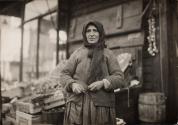 [Woman selling vegetables from street stand]
