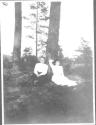 Adelaide Hubbell and Mary Mulligan resting beside tree, Oak Lodge Trip