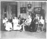 George Eastman and guests in living room, Oak Lodge Trip