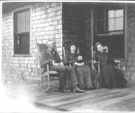Walter Hubbell, Mary Mulligan and Josephine Dickman on porch, Oak Lodge Trip