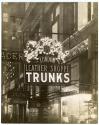 [Street scene with sign for London Leather Shoppe Trunks]
