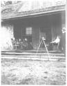 George Eastman photographing guests on porch, Oak Lodge Trip
