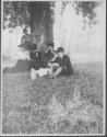 George Eastman and guests picnicing beside tree, Oak Lodge Trip