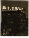 [Night time view of United Bank, with illuminated sign]