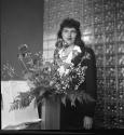 [Nancy Newhall by a vase of roses]