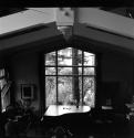 [Room with a piano in front of a window]