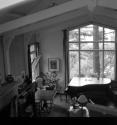 [Room with a piano in front of a window]