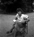 [Woman sitting in a chair]