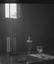 [Glasses and plates by window shutters]