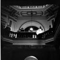 [People standing along second floor balustrade]