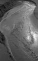 [Water ripples along sand of beach]
