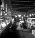 [People shopping at indoor market]
